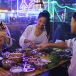 Group of young asian woman enjoying eating korean barbecue at restuarant.