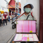 man selling tickets to thai lottery for foreigners