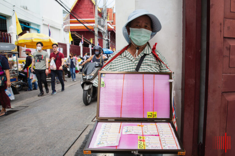 man selling tickets to thai lottery for foreigners