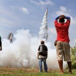 men launching rocket at yasothon-rocket-festival-thailand